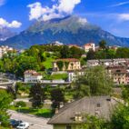 Breathtaking panorama of beautiful Belluno town surrounded by Dolomite mountains, northern Italy Von Freesurf